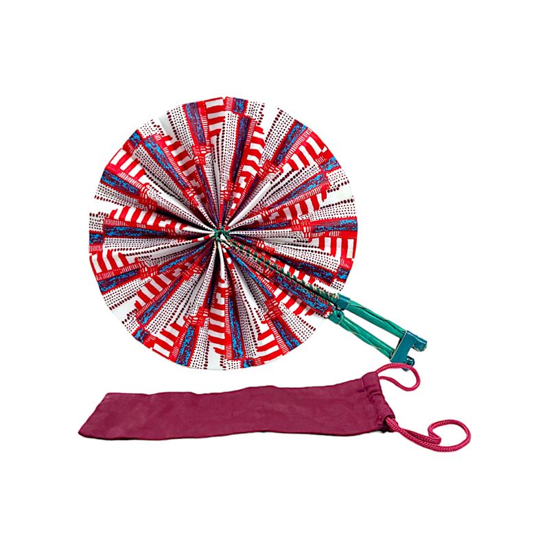 A vibrant circular hand fan with a pattern of red, white, and blue geometric shapes. It has a green handle, evoking a lively and festive tone.