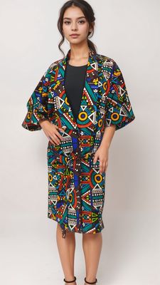 A woman wearing a colorful, geometric-patterned coat looks confidently at the camera. The coat features vibrant triangles and circles on a dark background.