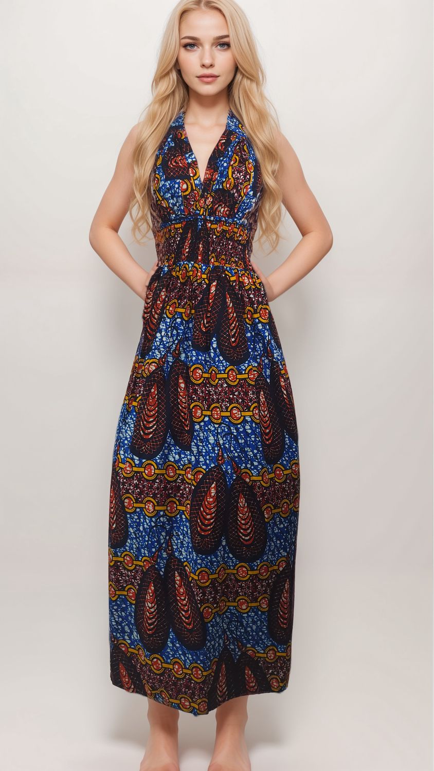 Young woman in a long, colorful dress with intricate patterns featuring blue, red, and yellow hues. Her expression is neutral and poised.