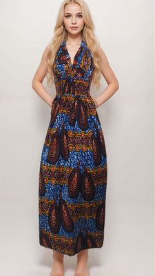 Young woman in a long, colorful dress with intricate patterns featuring blue, red, and yellow hues. Her expression is neutral and poised.
