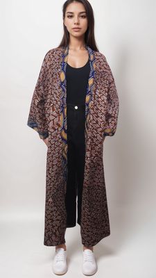 Model showcases a stylish long leopard print coat paired with a vibrant brown African print kimono.