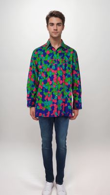 A man models a bright green, blue, pink and aquamarine patterned shirt, featuring an array of colors that create a lively and eye-catching design