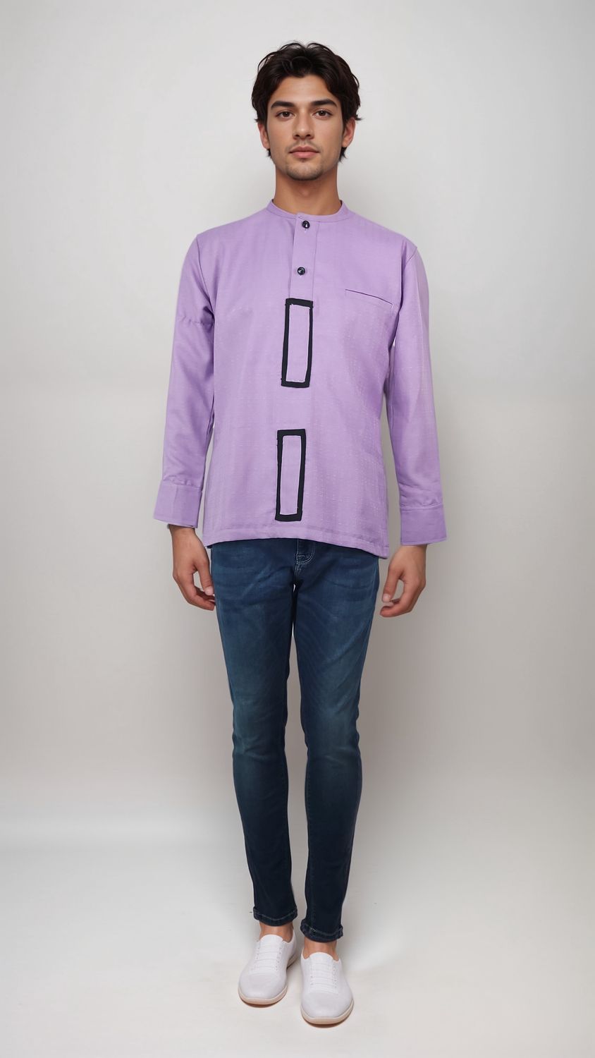 A man in a vibrant purple shirt and casual jeans stands confidently, showcasing a stylish and relaxed look