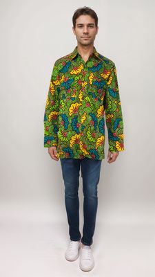 A man in a strikingly colorful African print shirt, radiating style and cultural richness with every hue.