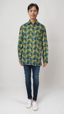 A man stands confidently, sporting a vibrant yellow and green shirt that catches the eye with its bold colors.