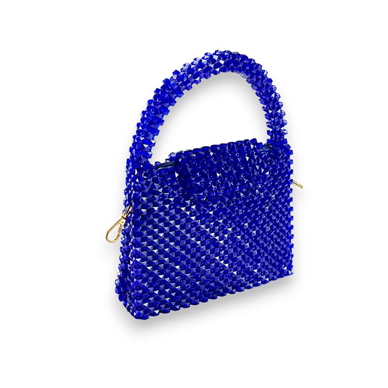 A handbag made of blue beads with a gold chain strap and a visible blue interior lining.