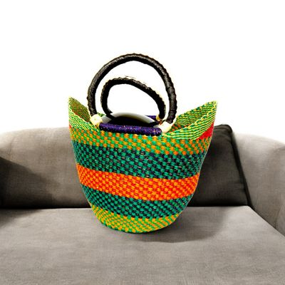 Colorful woven basket with orange handles, featuring colors and  patterns. The design is bold, with a bright, cheerful tone.
