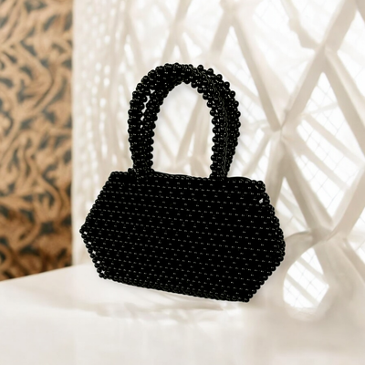 Black beaded handbag with a glossy finish. The geometric shape and intricate beadwork create an elegant and sophisticated look.