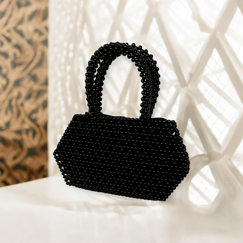 Black beaded handbag with a glossy finish. The geometric shape and intricate beadwork create an elegant and sophisticated look.