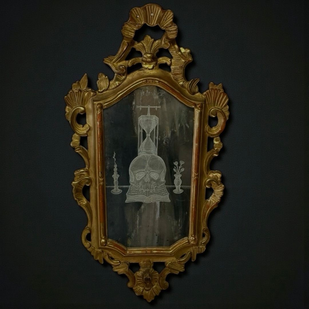 Magnificent mirror with gilded wooden frame and Memento Mori themed decoration