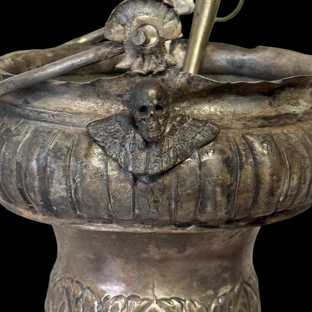 Processional holy water stoup in silver-plated copper with memento mori appliques Italy, late 19th century.