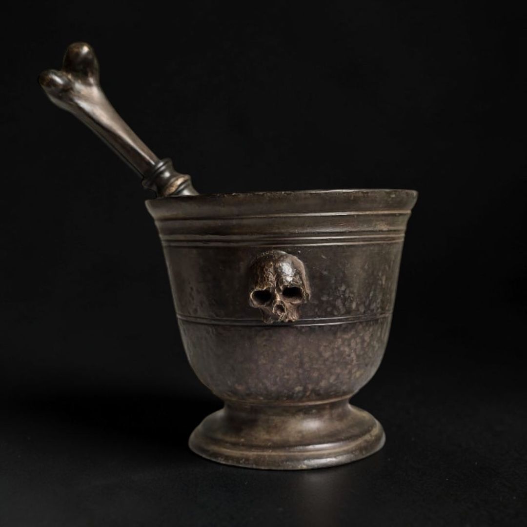 MEMENTO MORI MORTAR WITH SKULLS AND BONE-SHAPED PESTLE Bronze, 18th century MEMENTO MORI MORTAR WITH SKULLS AND BONE-SHAPED PESTLE Bronze, 18th century