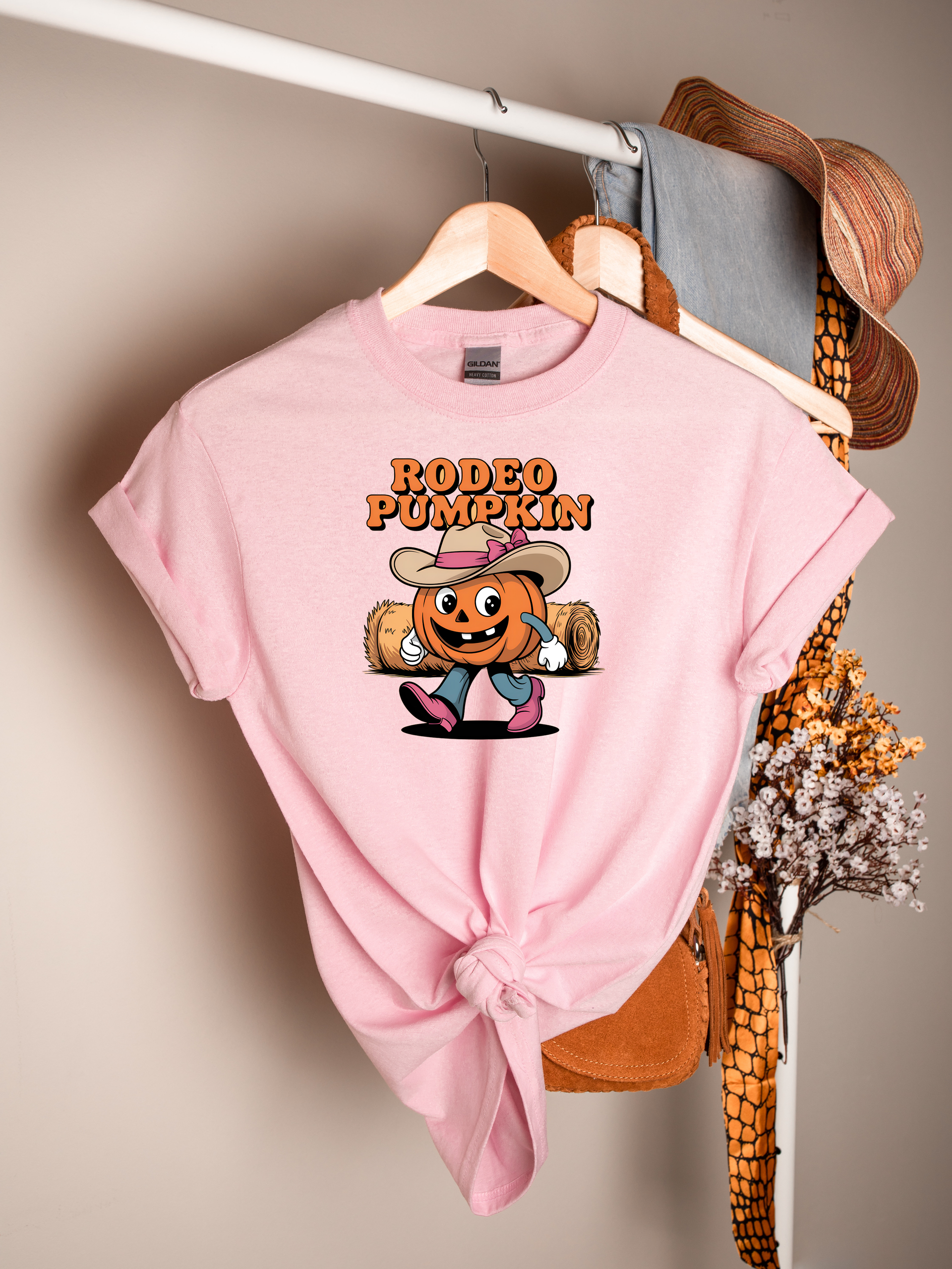 Rodeo Pumpkin with Cowgirl hat with pink bow wearing pink boots graphic apparel