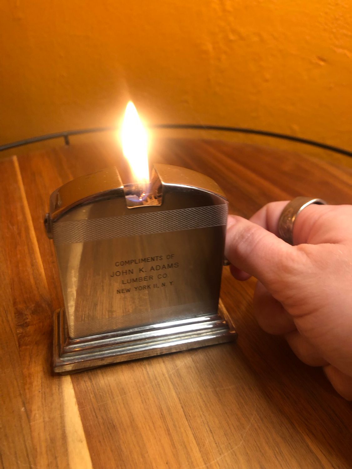 Compliments Of John K Adams Press Lever Table Lighter