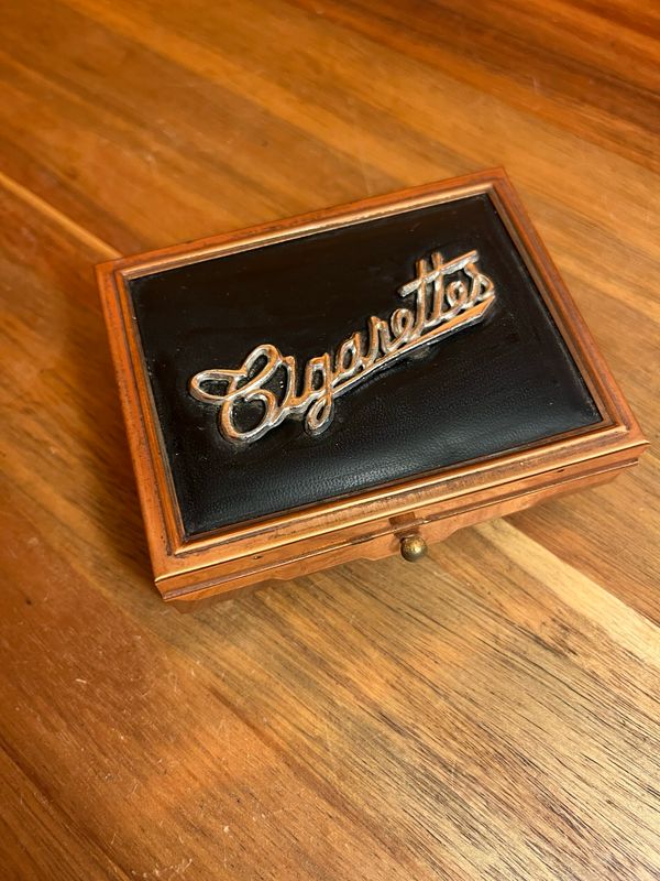 Black &amp; Golden Cigarettes Legged Holding Box