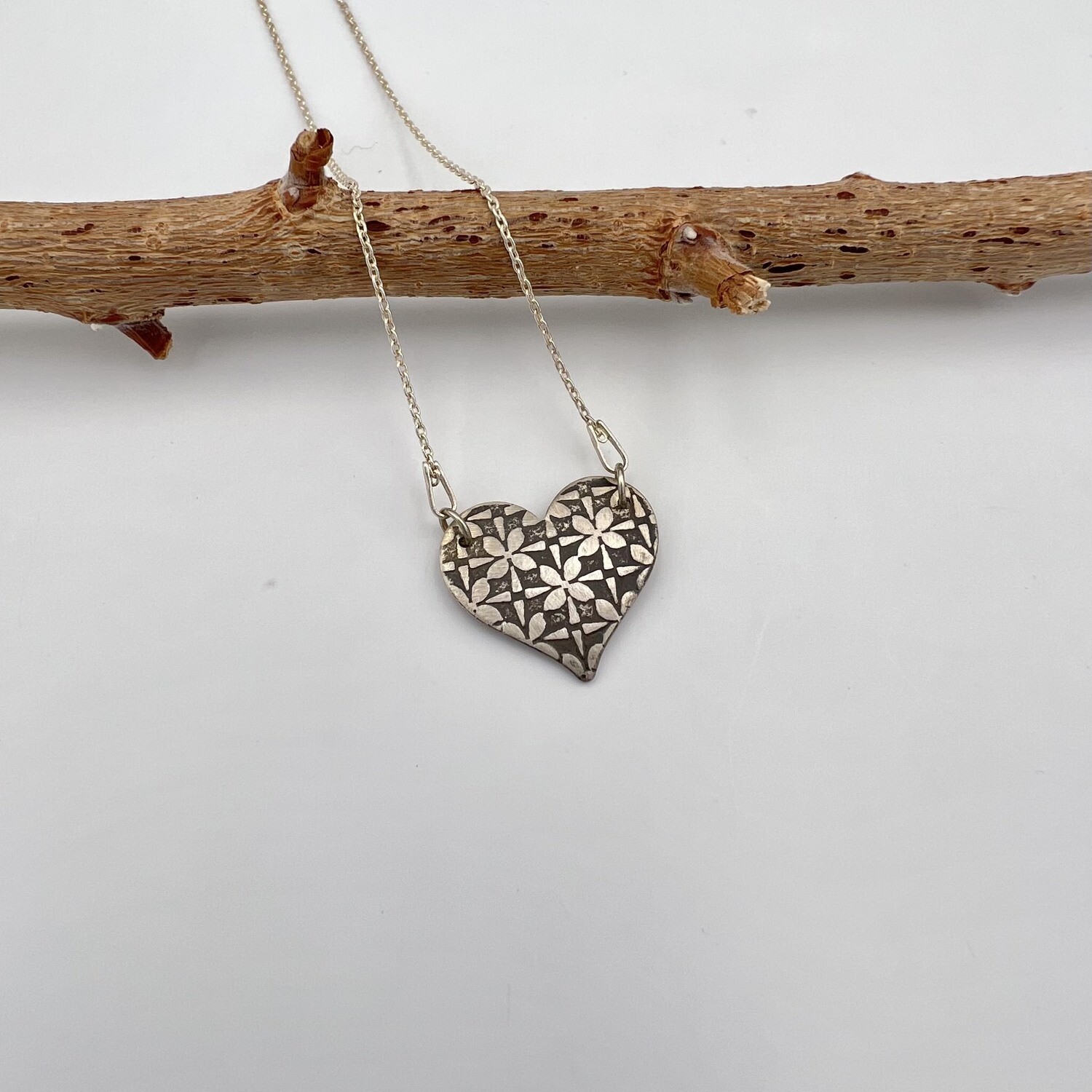 Oxidized Sterling Silver Heart Pendant with a Flower Screen Pattern Oxidized Sterling Silver Heart Pendant with a Flower Screen Pattern