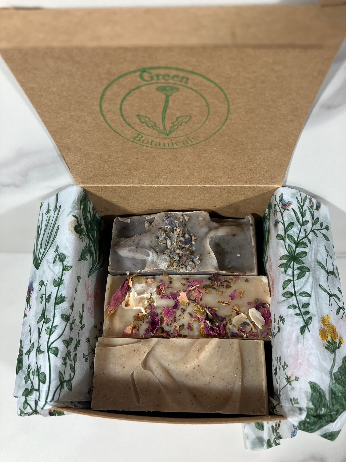 Three natural essential oil herbal soaps in Kraft box tied with raffia