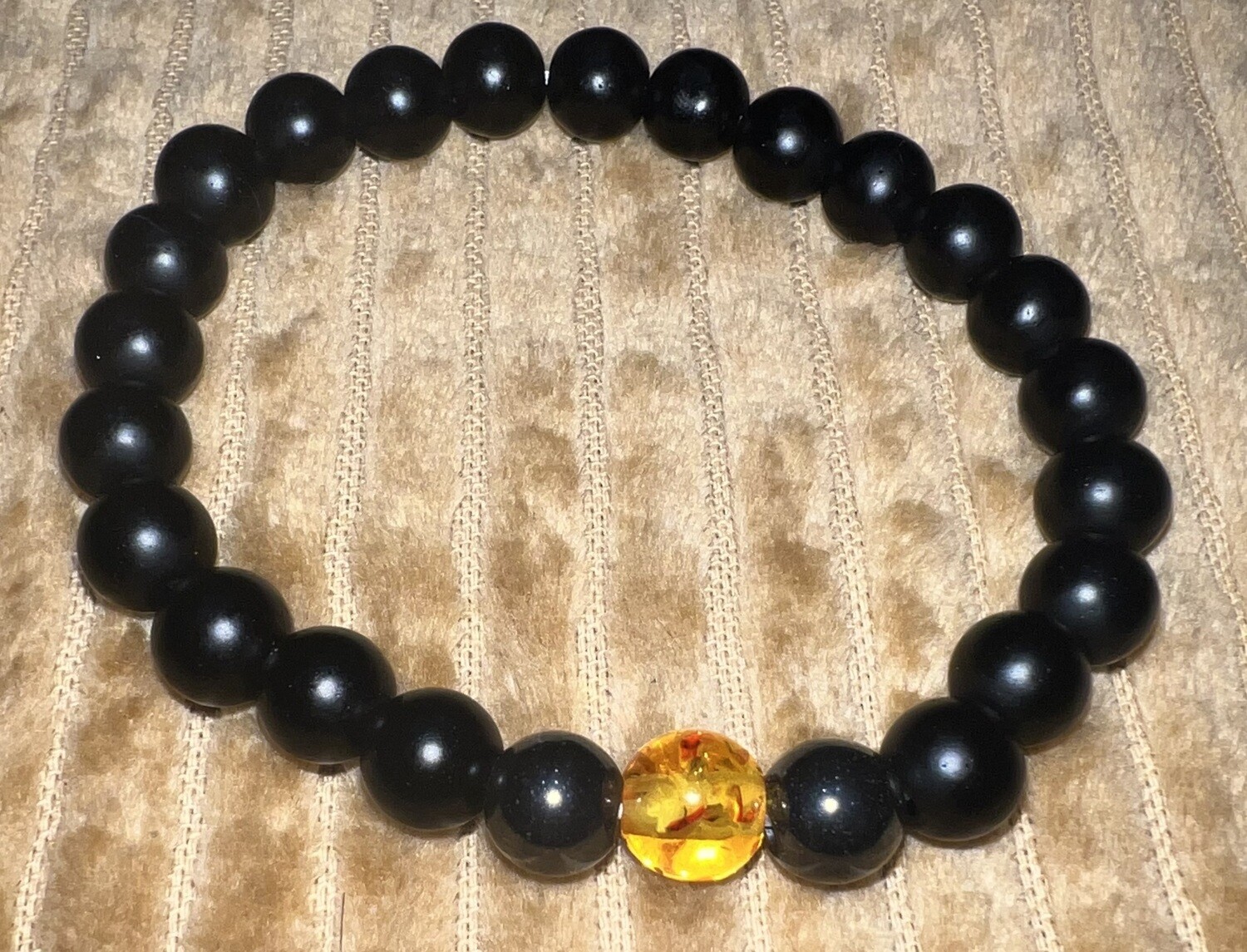 Black beaded bracelet with amber detailing