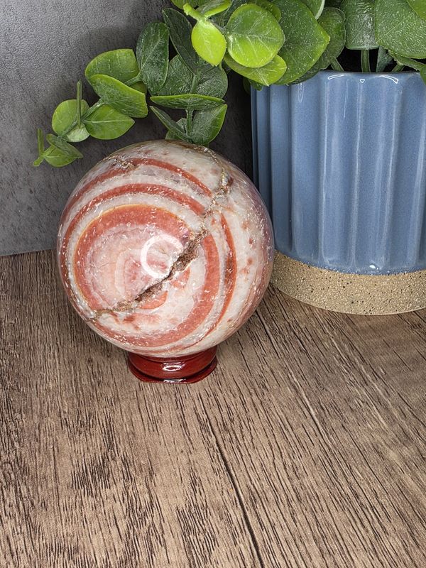 Rhodochrosite sphere w/wooden stand
