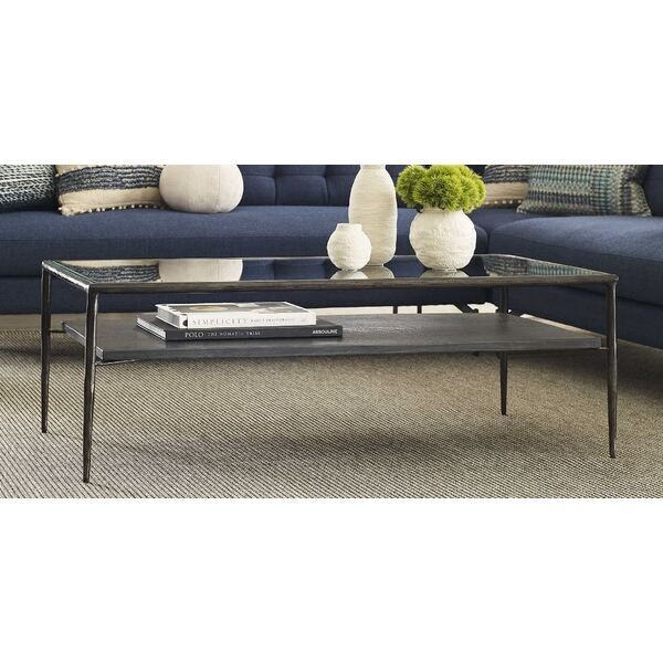 Iron Legged glass top cocktail table uttermost