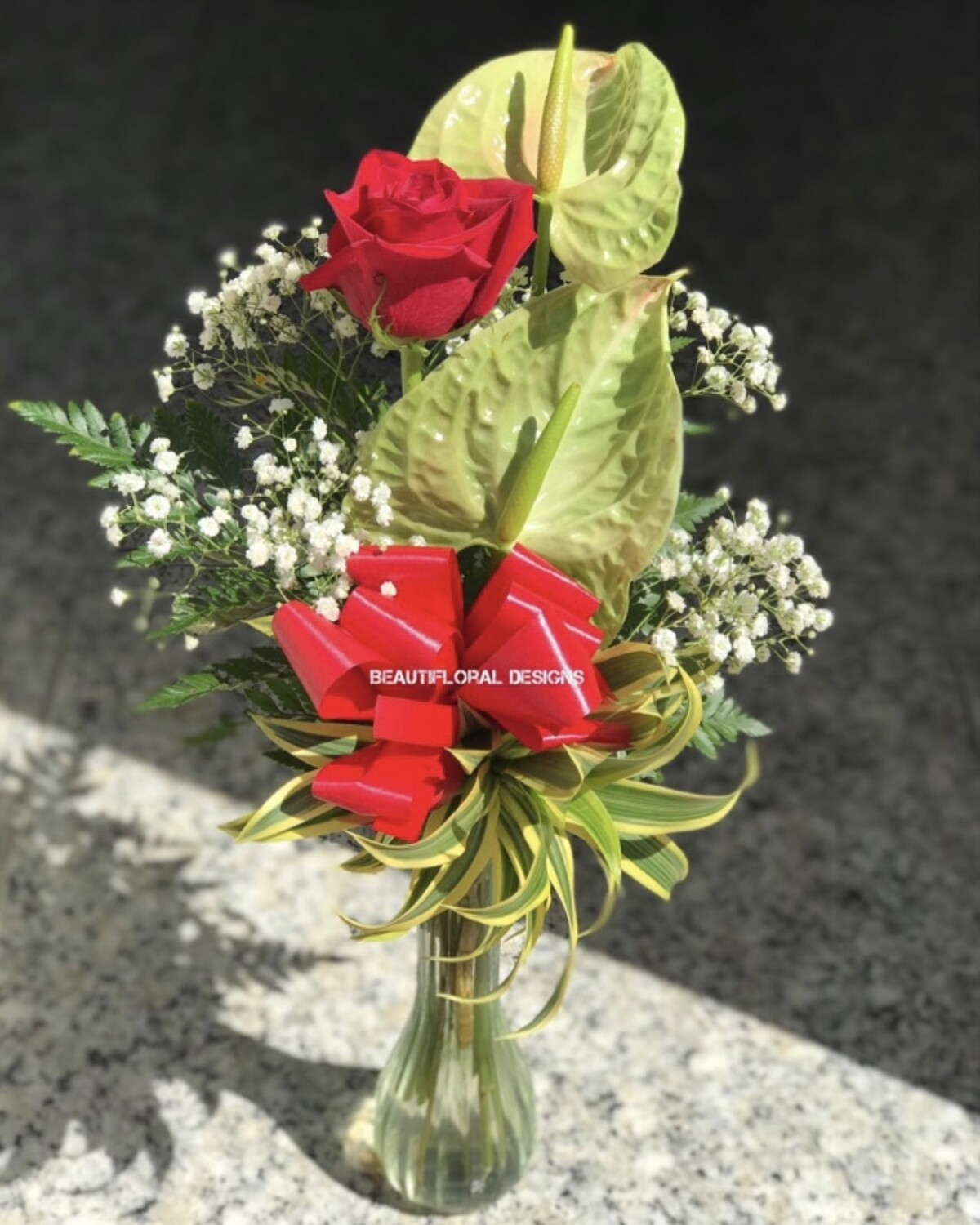Rose &amp; anthuriums in a vase