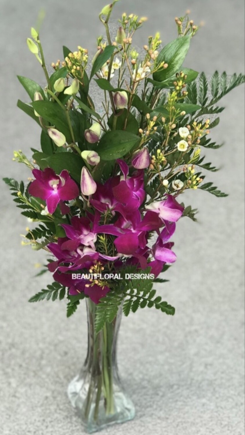 3 purple Orchids in a vase
