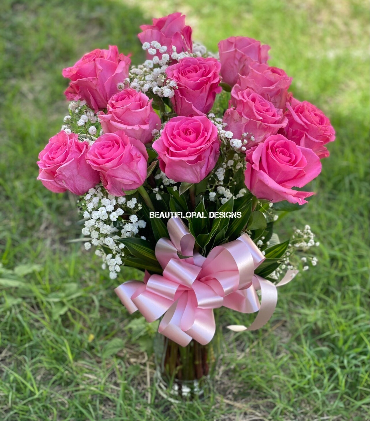 12 pink roses in a vase