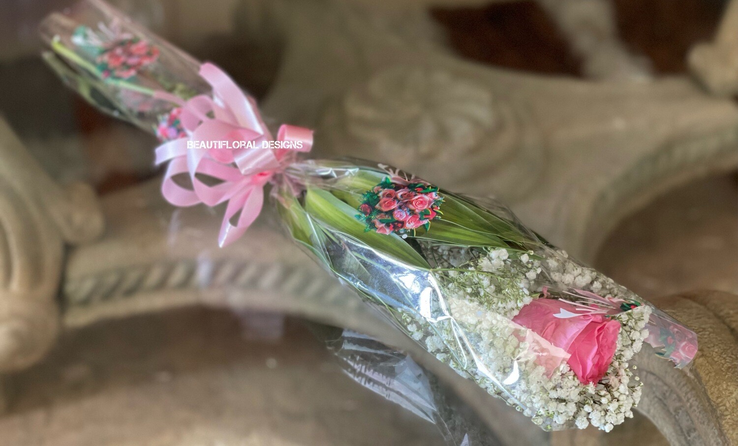 1 pink rose in a sleeve