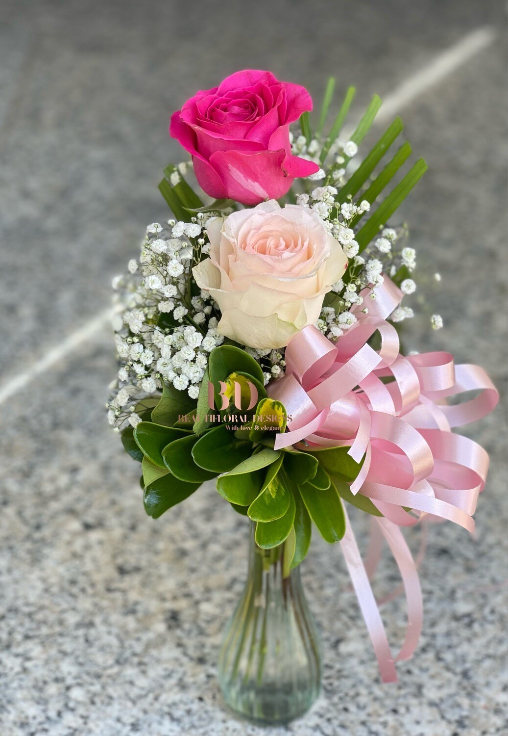 2 pink roses in a vase
