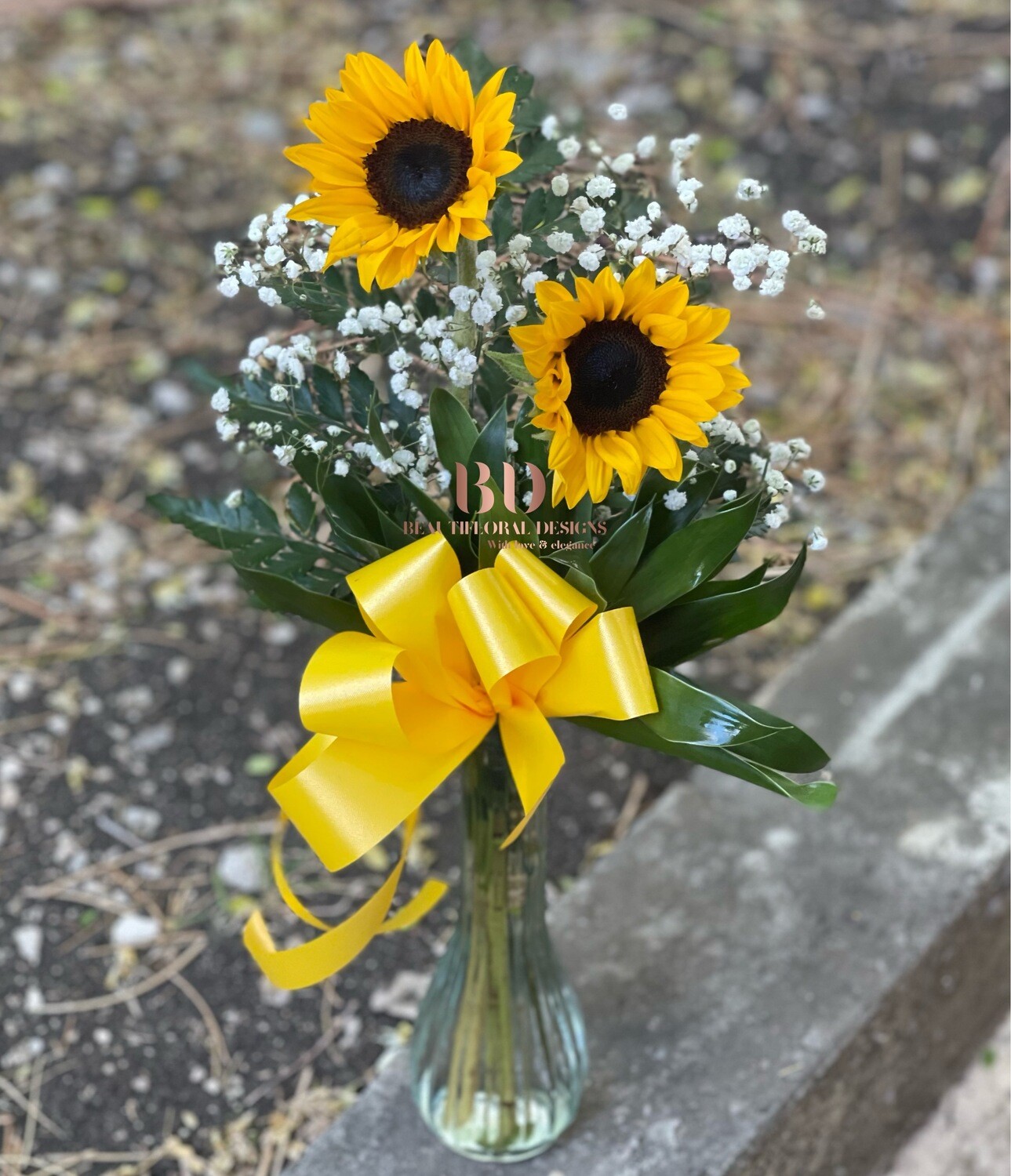 2 sunflowers in a vase
