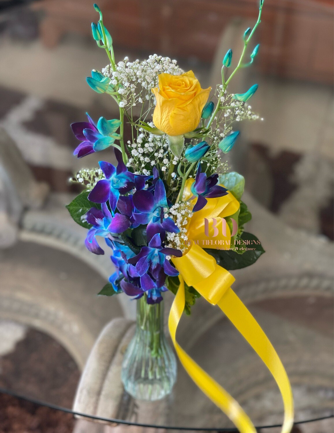 2 orchids, 1 rose in a vase