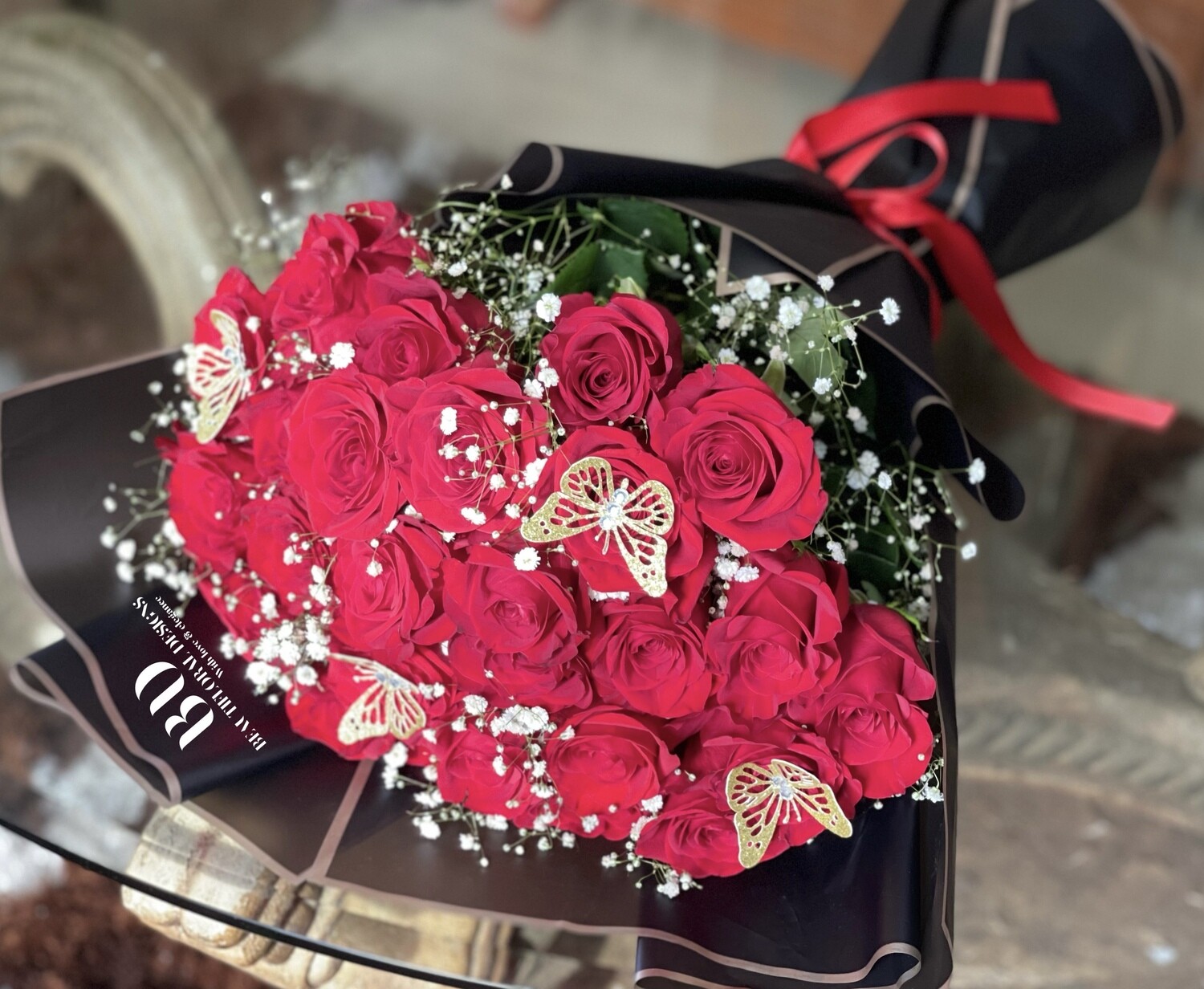 30 red roses in lux wrap with butterfly accents