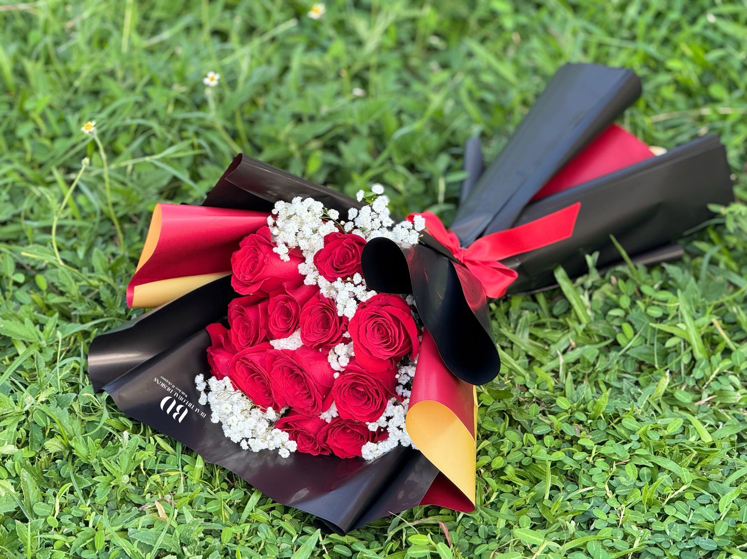 12 roses in black lux wrap