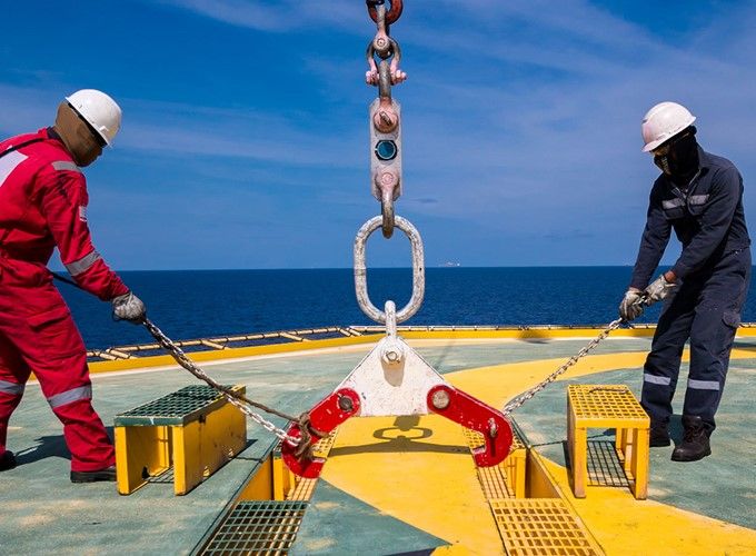 LOLER awareness training with two men on a helideck and a crane lifting