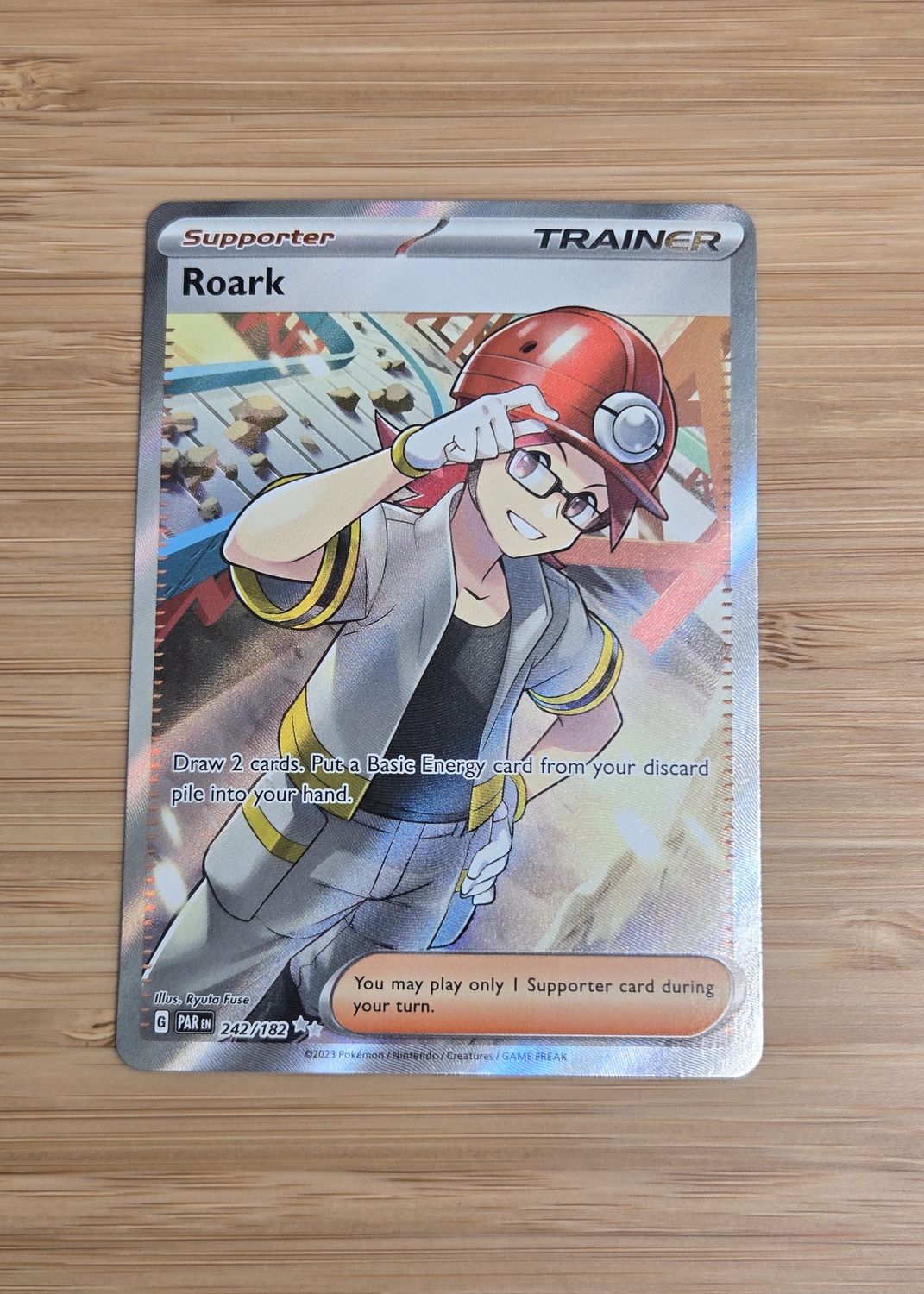 Roark Trainer - 242/182 - Paradox Rift - NM