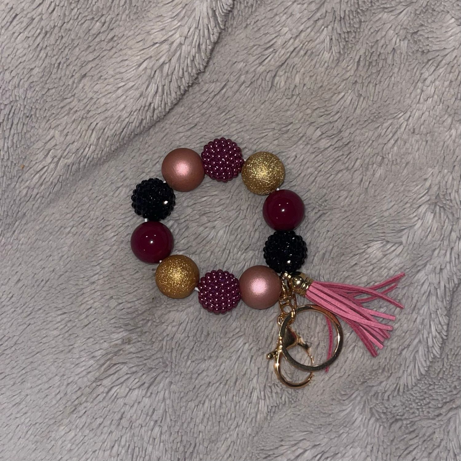 Gold, Maroon Black, AndMauve With Tassel Wristlet