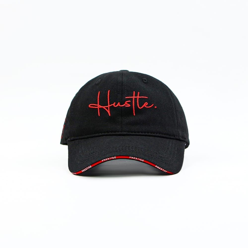 Black baseball cap with “Hustle.” embroidered in a red script