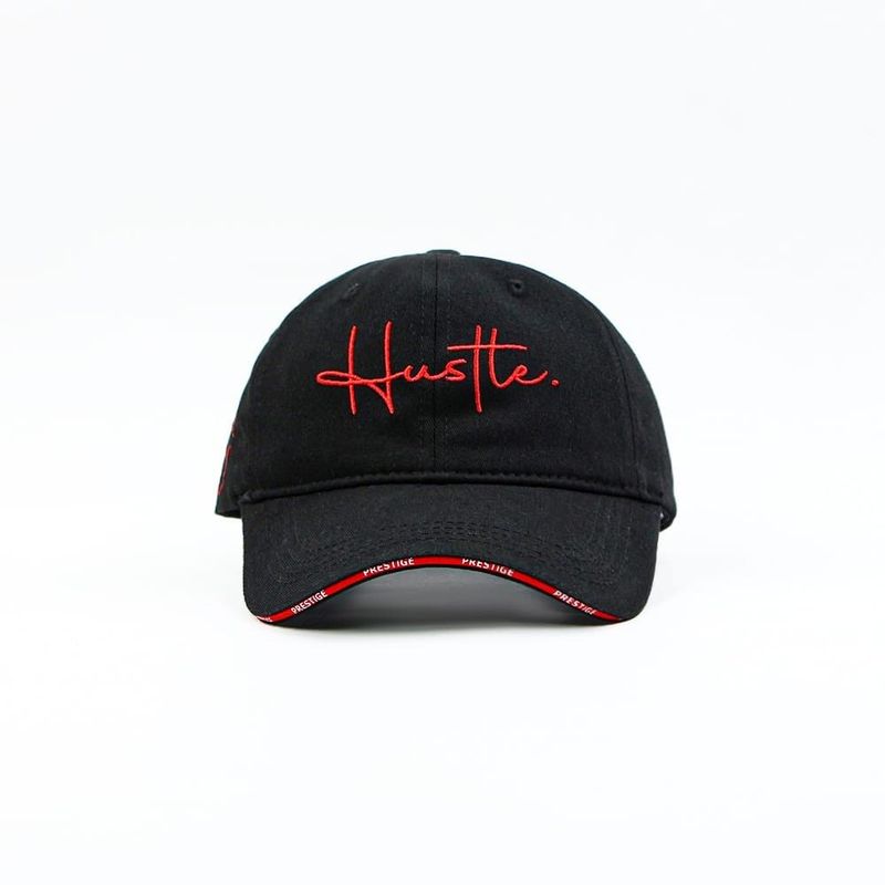 Black baseball cap with “Hustle.” embroidered in a red script