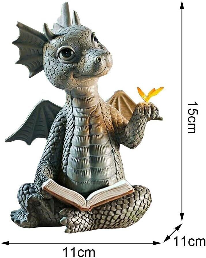 Estatua de libro de lectura de dragón bebe