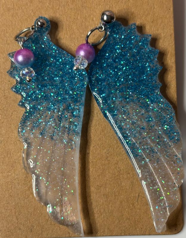 Blue and white resin glitter angel wing earrings