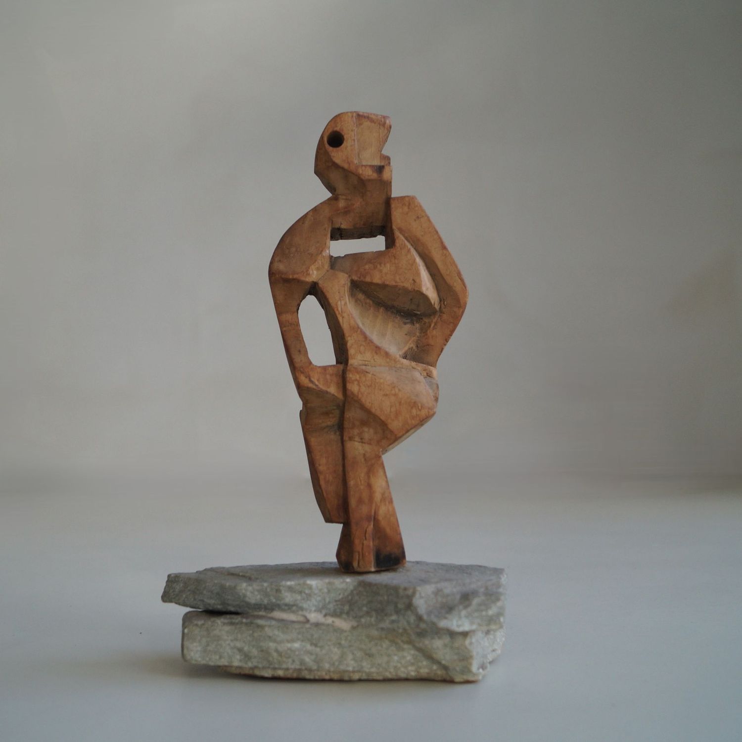 On Hold: Vintage cubist wooden sculpture on natural stone base, 1960s