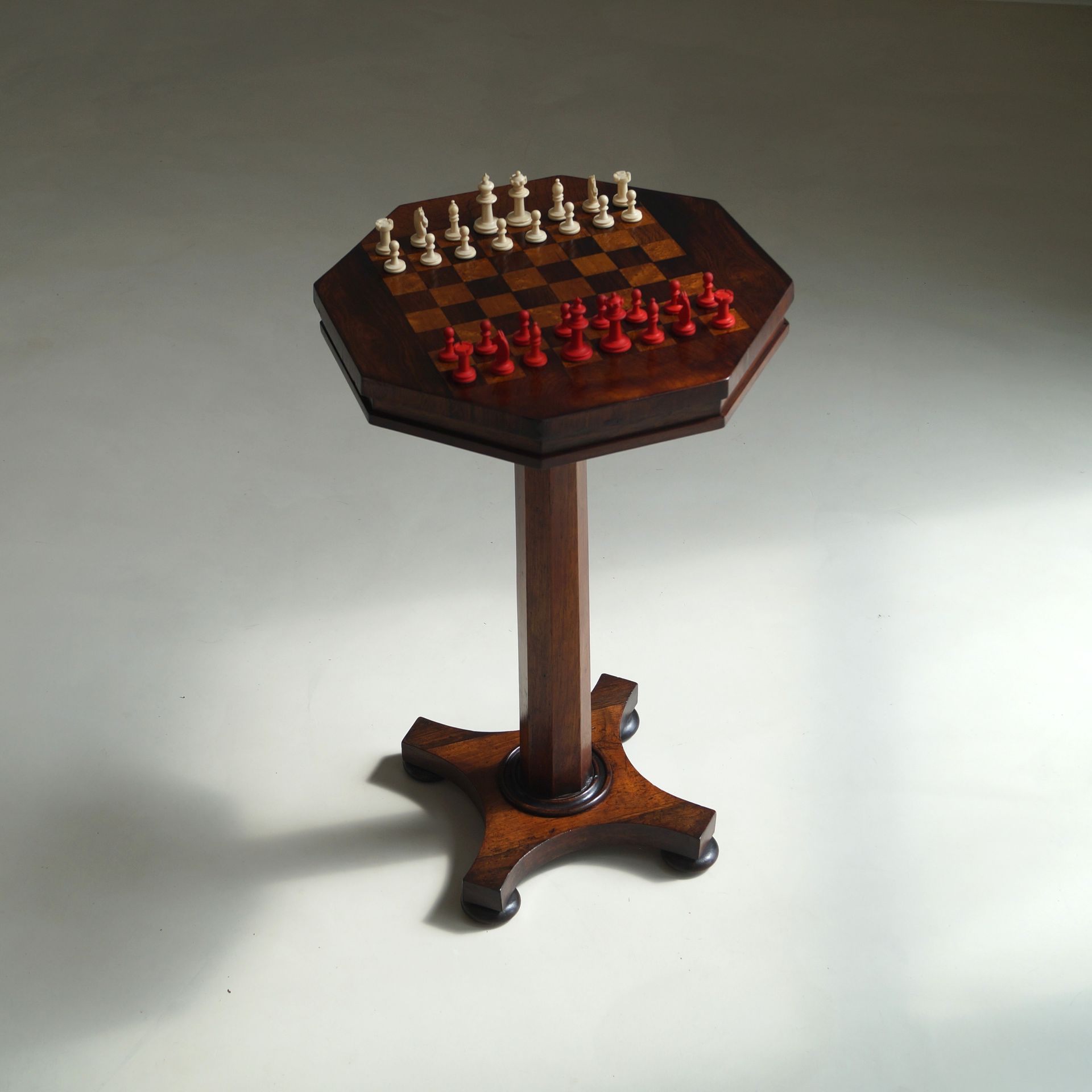 A rare antique octagonal chess table and a vintage chess set