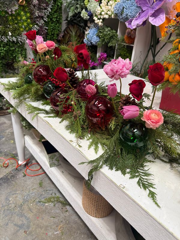 Holiday arrangement with live flowers and live garland