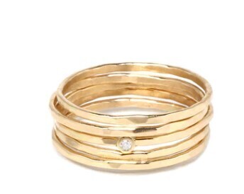 Ring- set of 5 14k thin hammered stack rings, one w/1 pt...diamond..