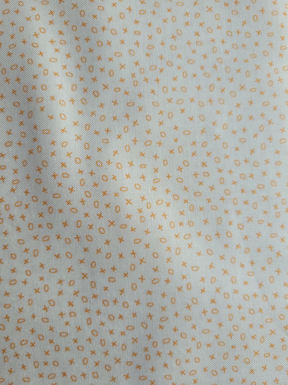 Tessuto bianco con piccoli disegni arancioni