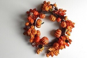 Autumn / Halloween Wreath with an array of golden orange fruits and berries and a scattering of pine cones and bark 380mm