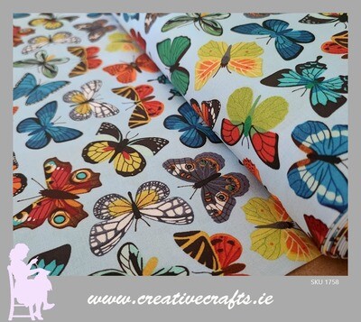 Cotton fabric with multicolored butterflies on a blue
