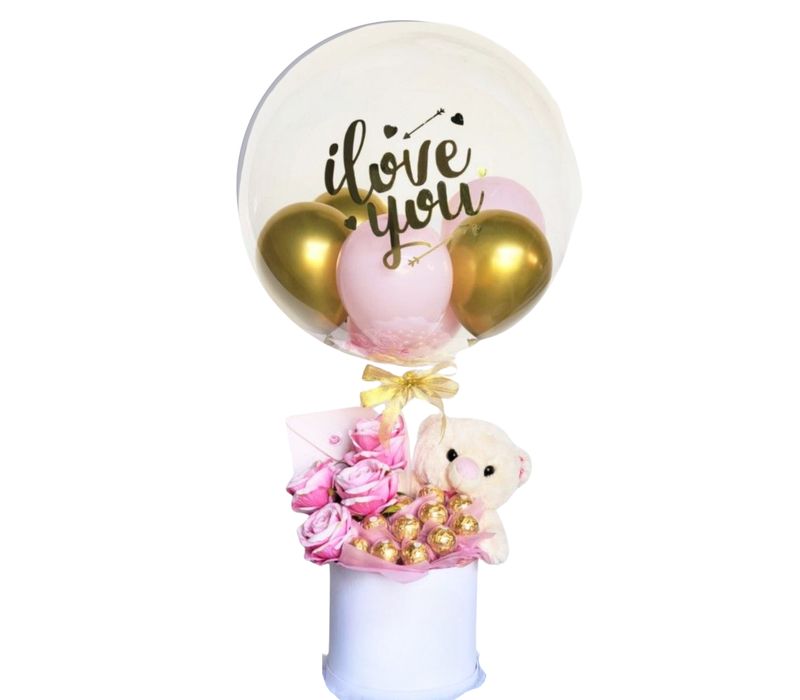 Pink Roses, Chocolates, Teddy Bear and 1 large clear balloon with writing on it.