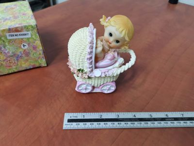 Porcelain baby in pink pram