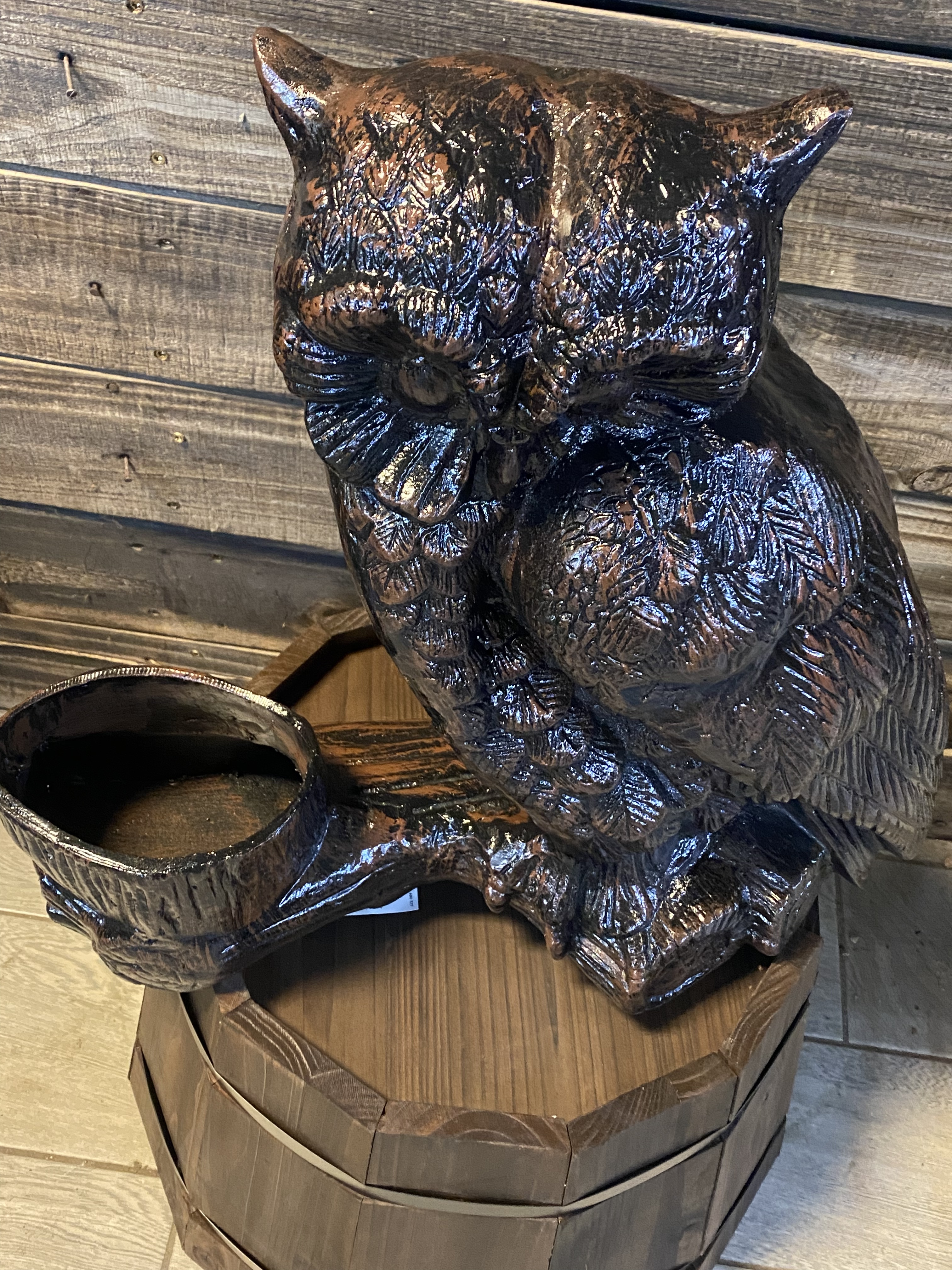 Owl sitting on log with planter